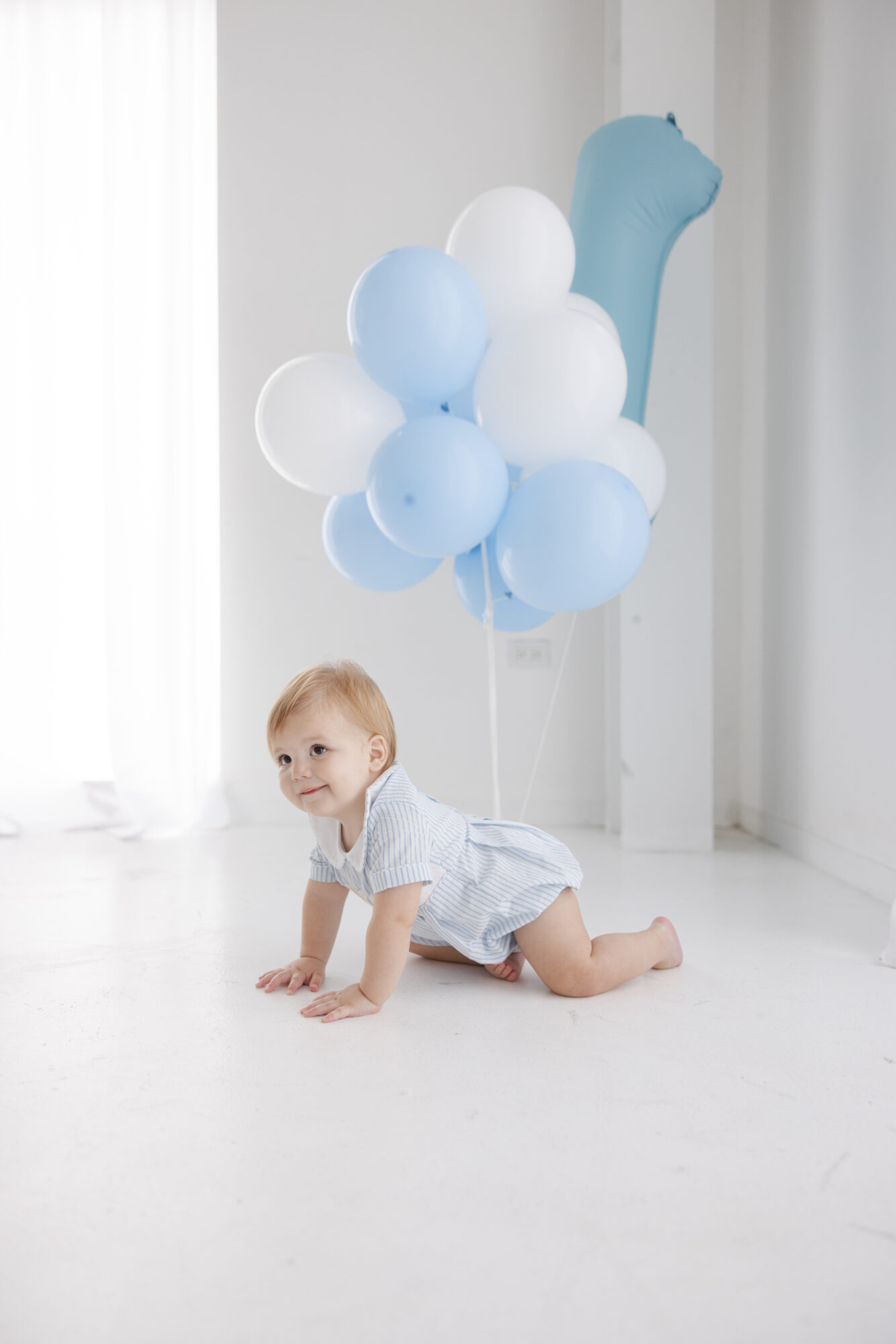 Baby boy in white studio in Houston for milestone children's session. 